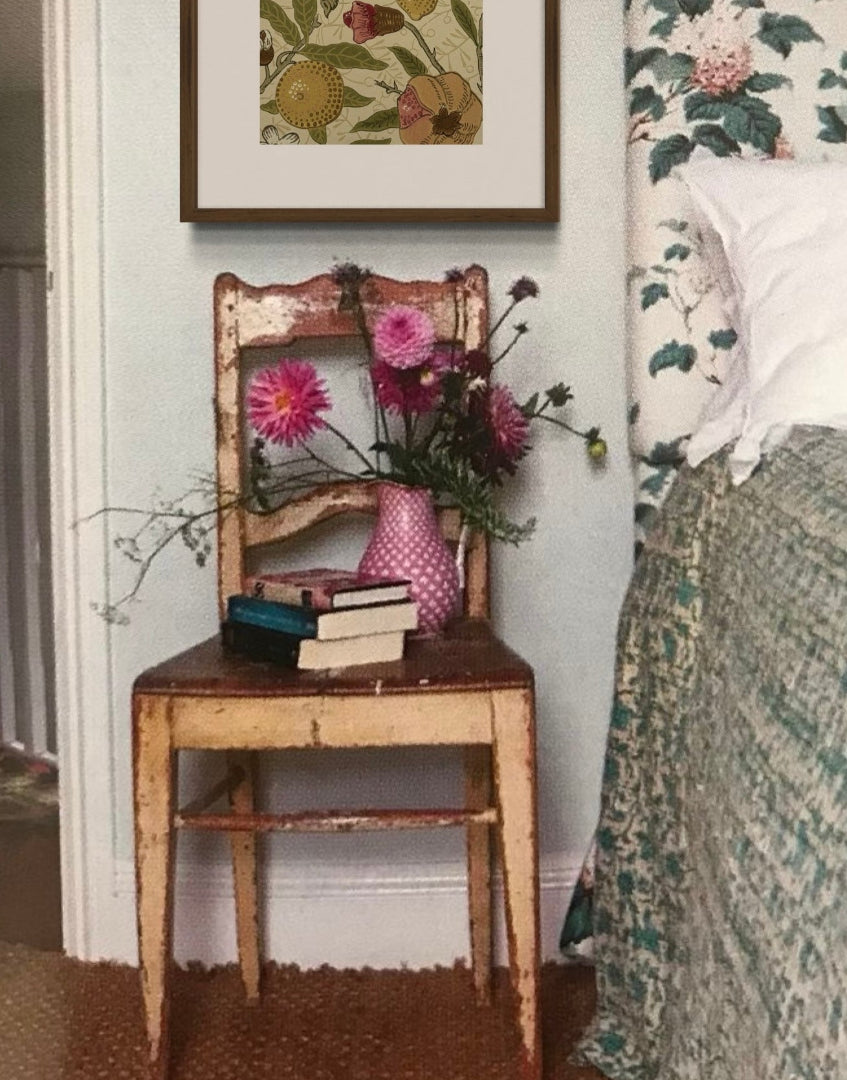Classi country style bedroom interior with chair and flowers and William Morris wall decor