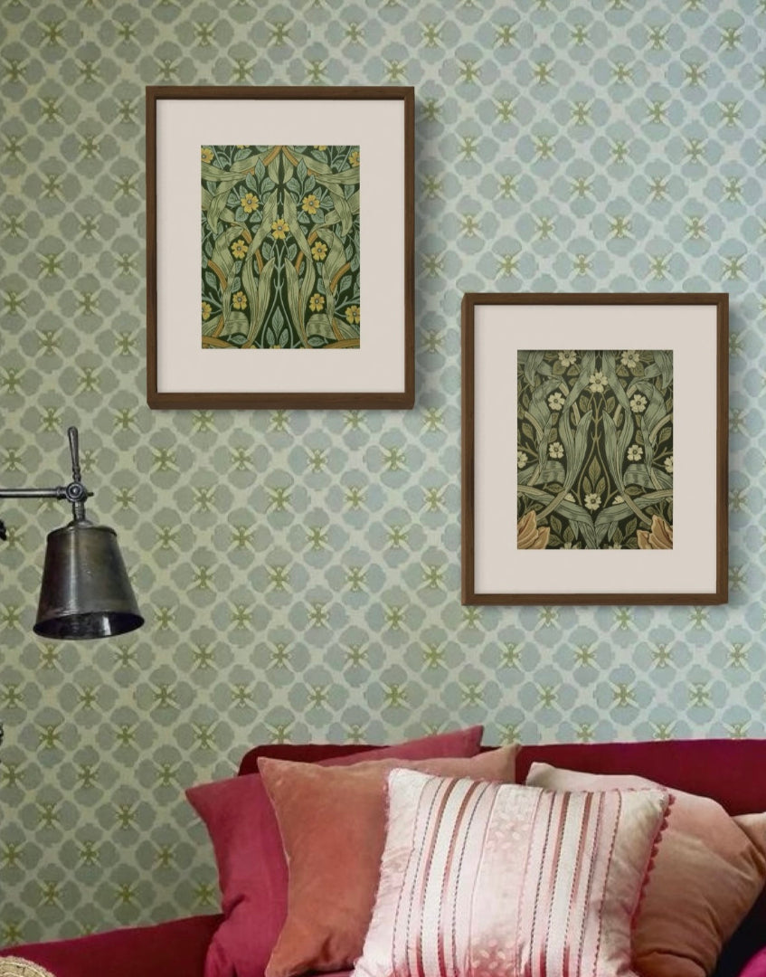 Bohemian interior with pink sofa and cushions, green wallpaper and industrial light with William Morris framed wall decor