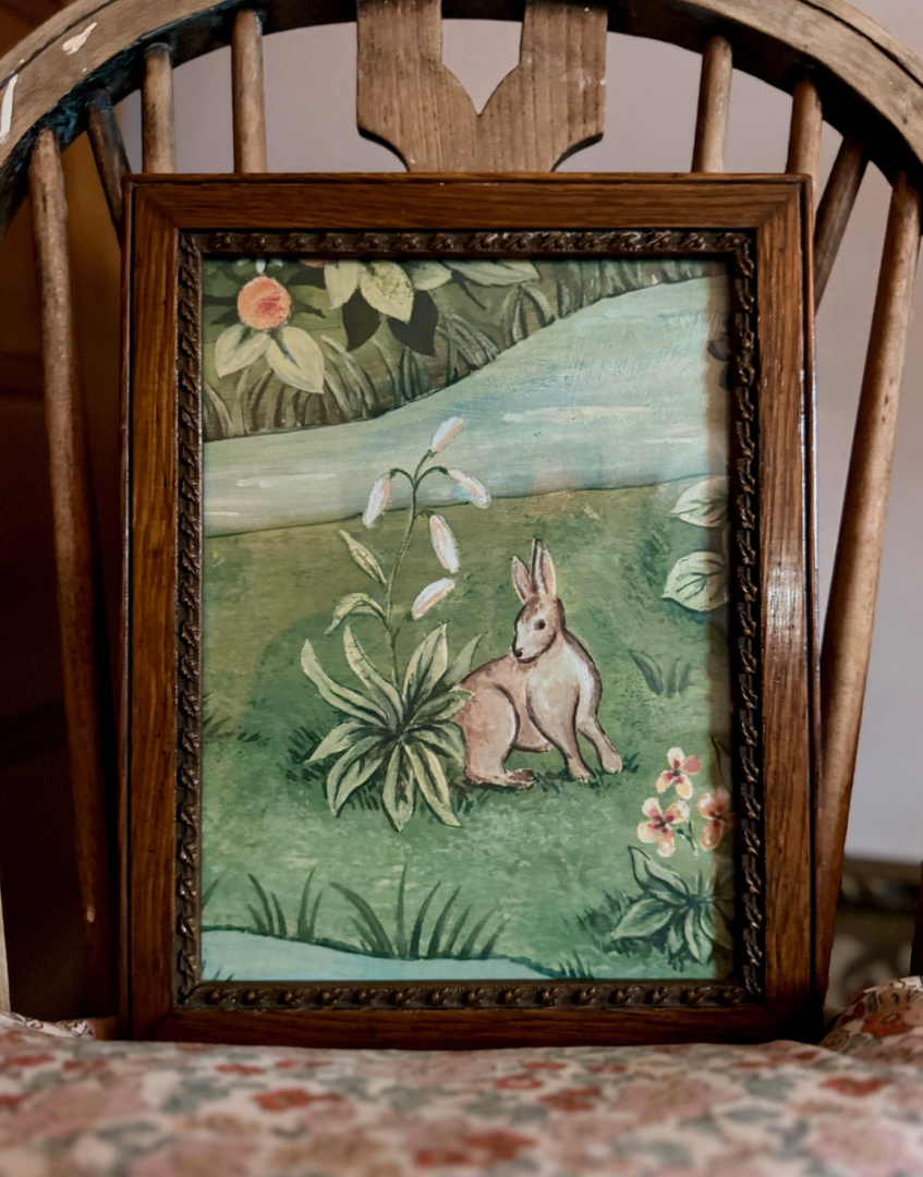 Antique framed William Morris print on floral cusion against back of antique wood chair