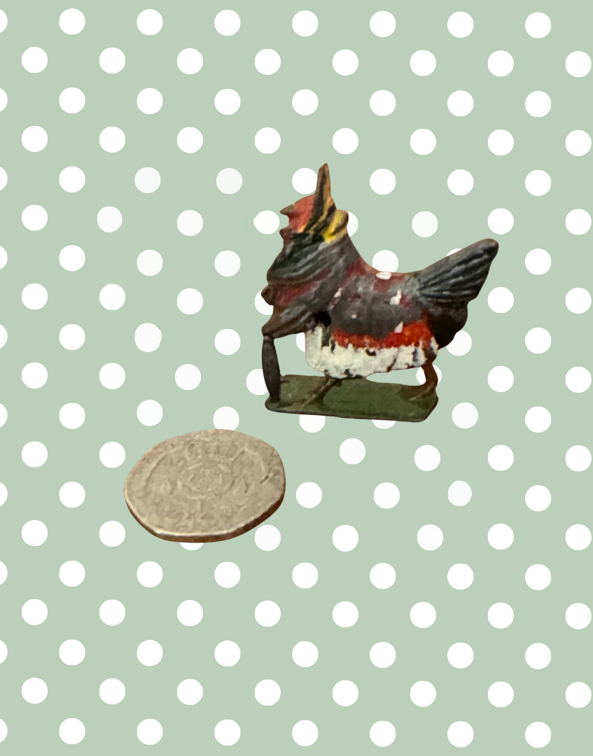 Henrietta ‘Fussy Feathers’ Britains Ltd Collectable next to twenty pence coin for scale