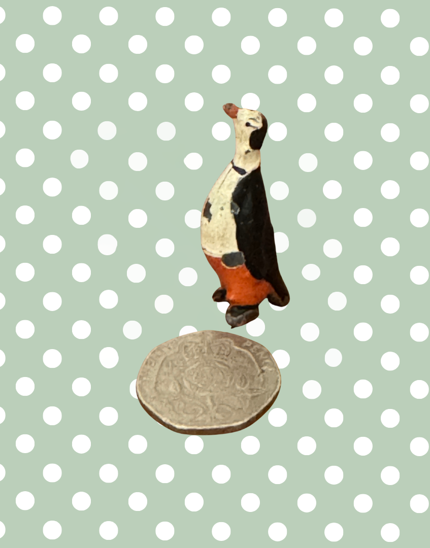 pete penguin miniature cadbury cococub collectible next to twenty pence coin to show scale