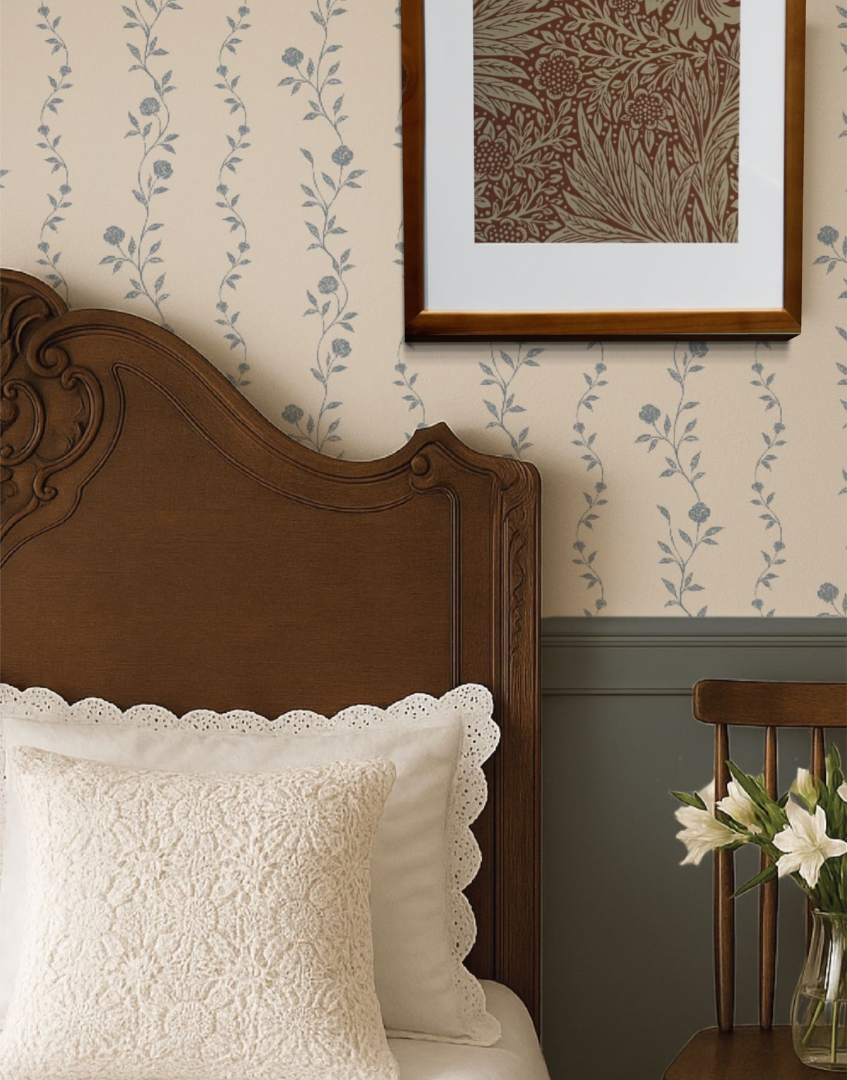Bedroom with wooden headboard, floral wallpaper, and framed William Morris Marigold artwork.