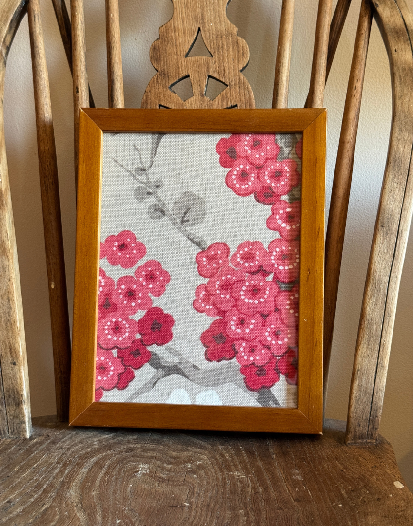 Pretty asian inspired pink floral framed art on antique wood seat.