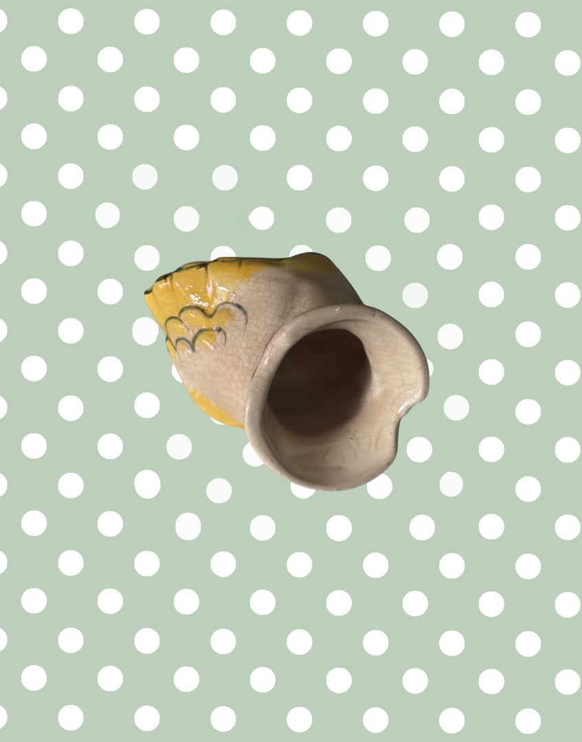 Underside of peach and yellow collectable pie bird kitchenware