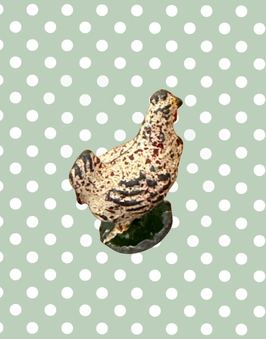 Small britains chicken lead figurine on a polka dot background