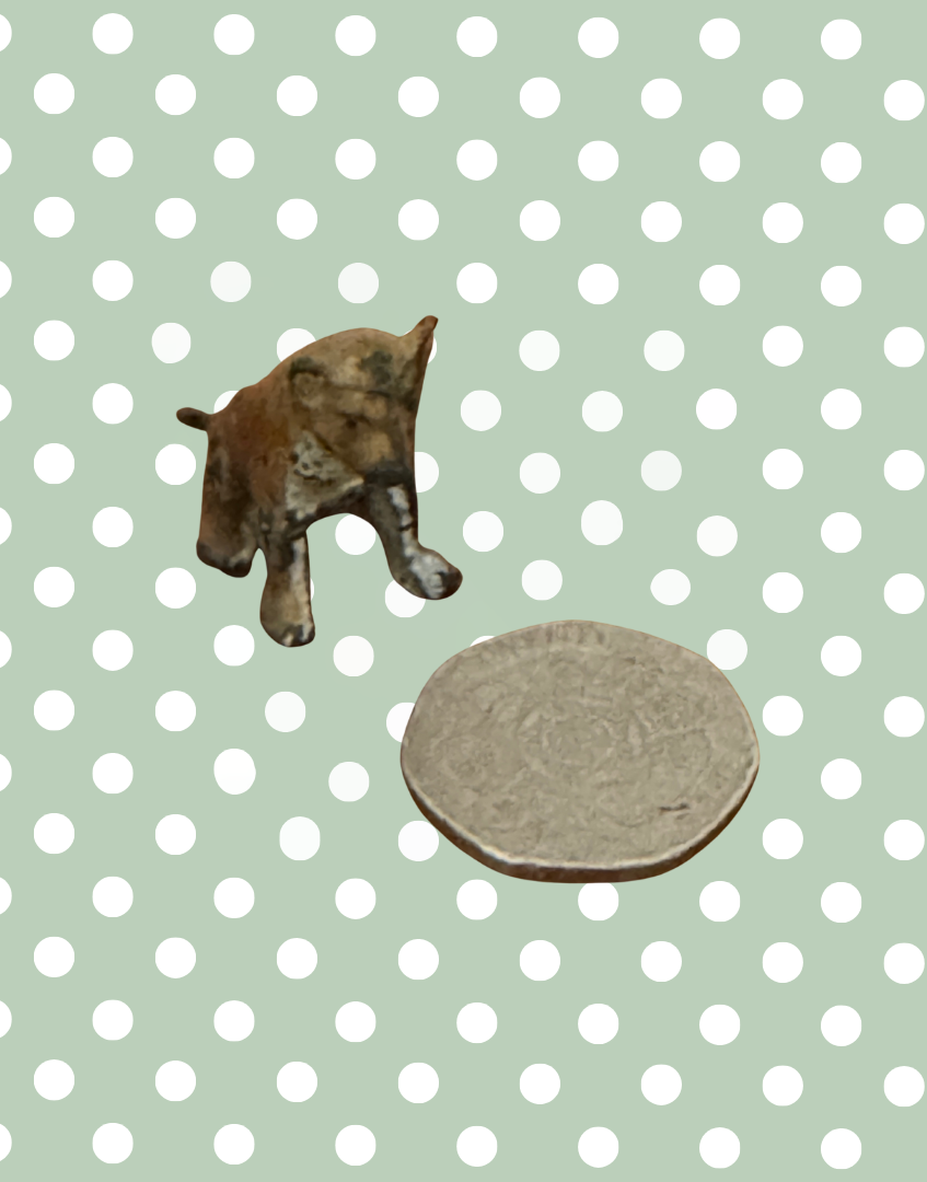 Miniature hand painted britains lead figurine lion cub next to twenty pence piece for scale