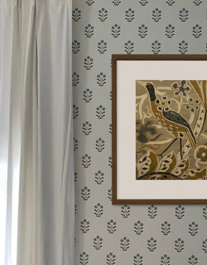 Light and airy interior with white curtain and white patterned wallpaper with William Morris framed artwork on wall