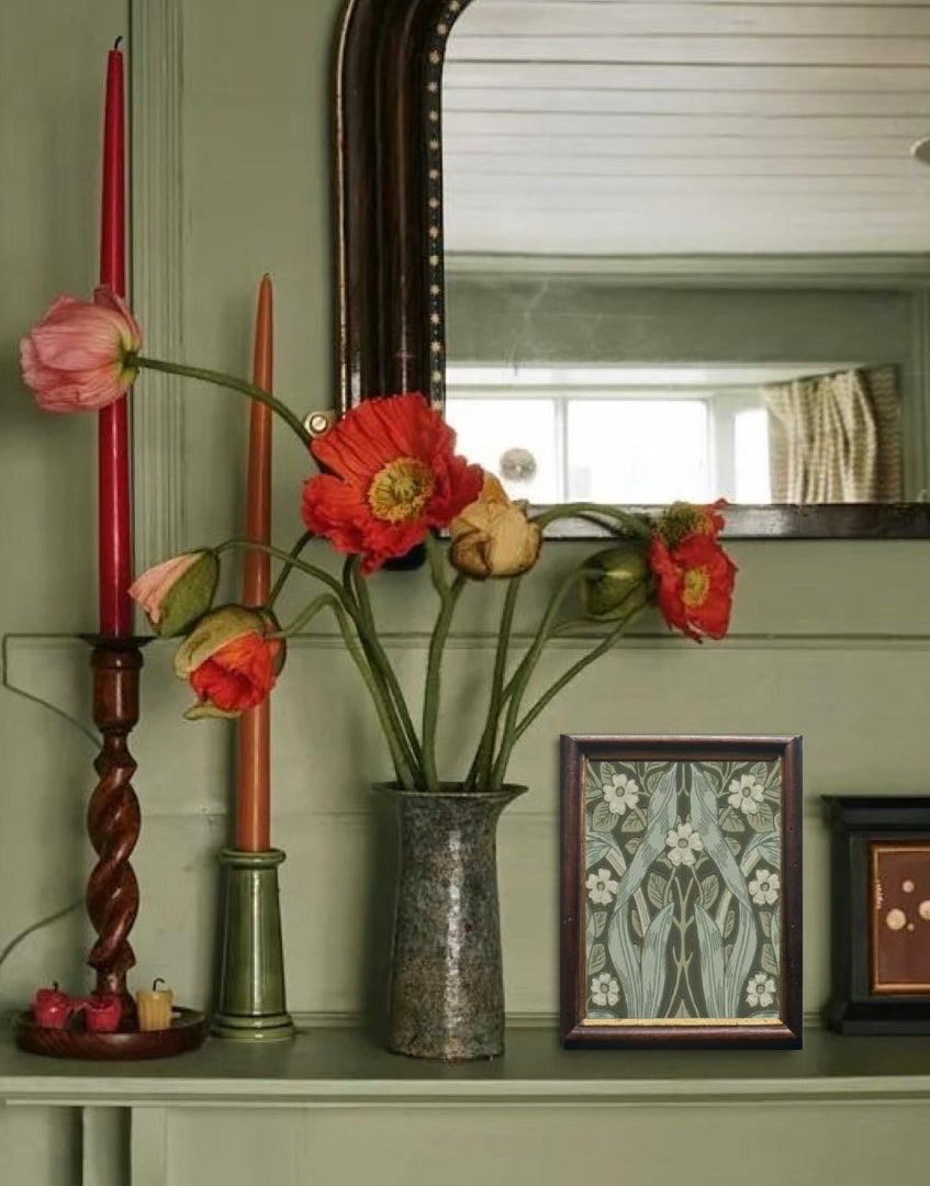Country style interior with green painted walls and mantle shelving styling with miniature antique framed William Morris print