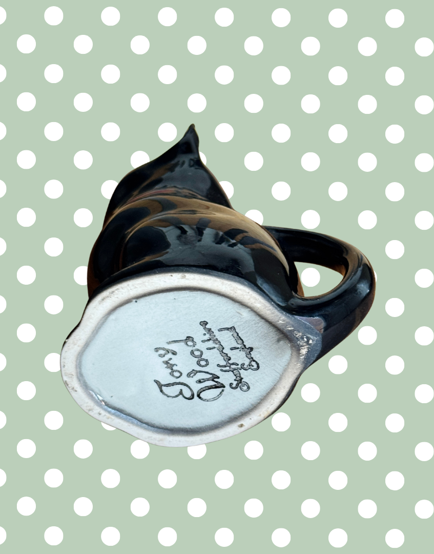 Base of black ceramic vintage car shaper milk jug with Tony Wood Staffordshire England maker stamp
