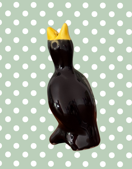 Traditional black and yellow glossy vintage classic pie bird baking tool with characterful eyes