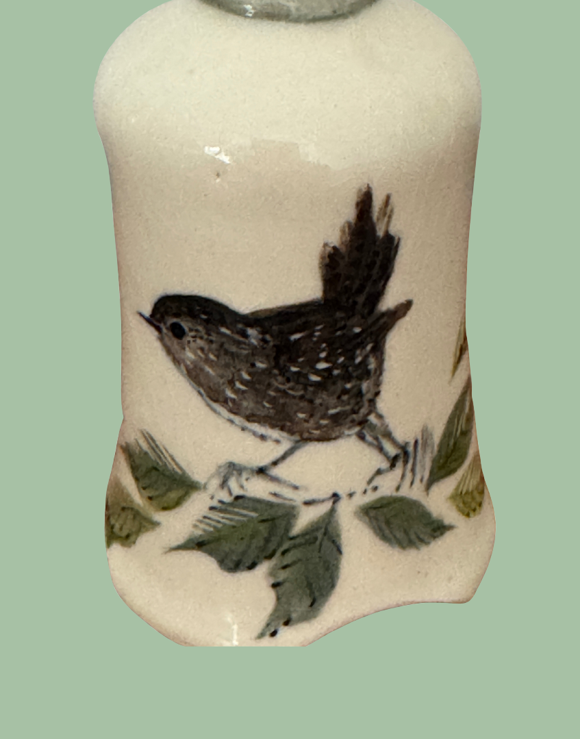 close up of charming british heritage wren llustration on vintage cermic pie