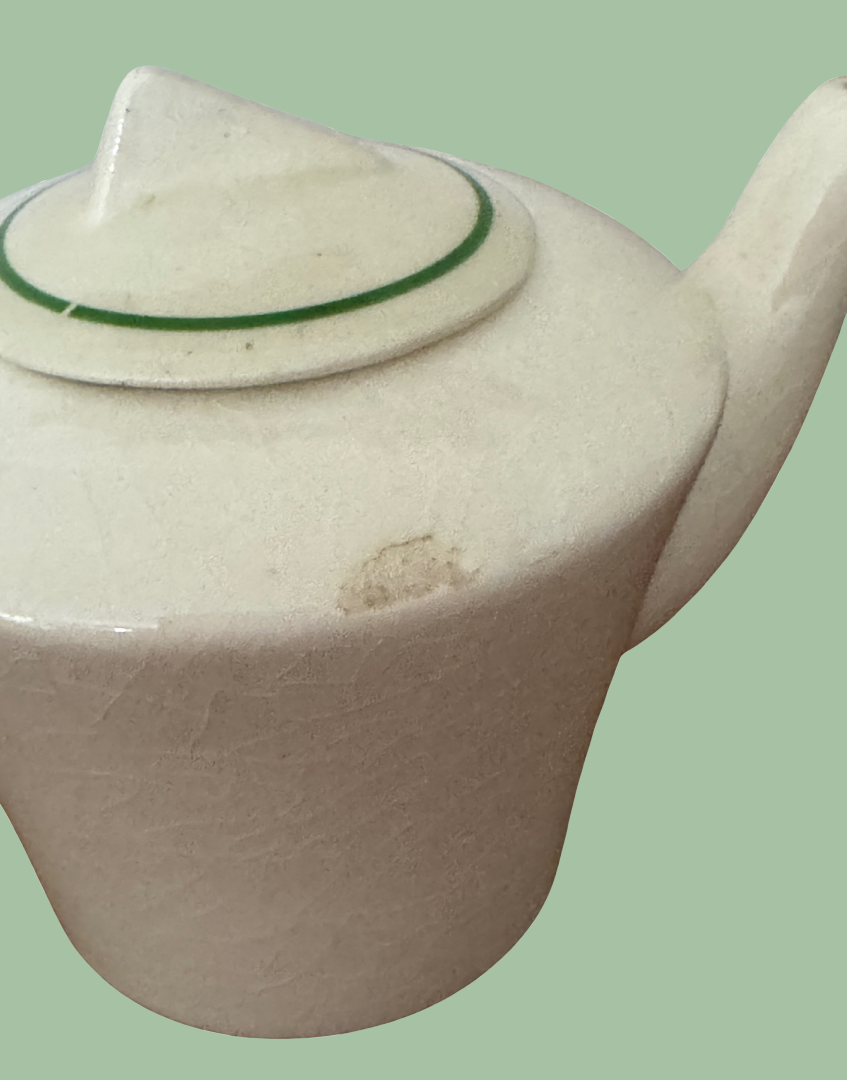 close up of small chip on side of art deco miniature childs playset teapot
