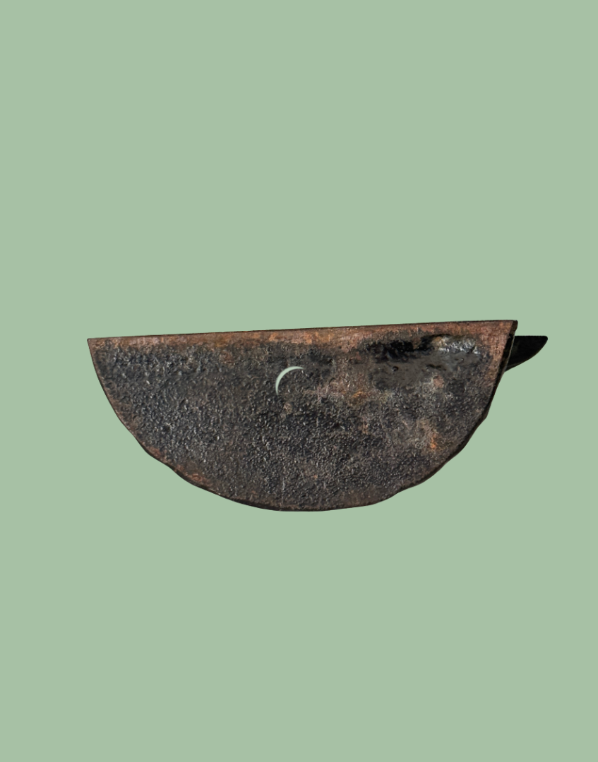 Base underside of vintage black cast iron frog doorstop showing aged