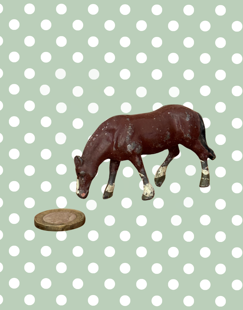 britains vintage lead farm collectible horse toy next to one pound coin