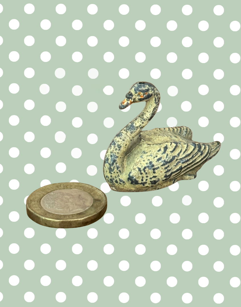 A cream swan swimming, version 2, showing some paint loss but retaining delicate shape and charm. This 1920s Britains figure is an ideal addition for collectors completing a vintage farmyard or waterfowl display.
