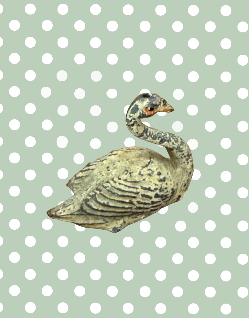 A cream swan swimming, version 2, showing some paint loss but retaining delicate shape and charm. This 1920s Britains figure is an ideal addition for collectors completing a vintage farmyard or waterfowl display.