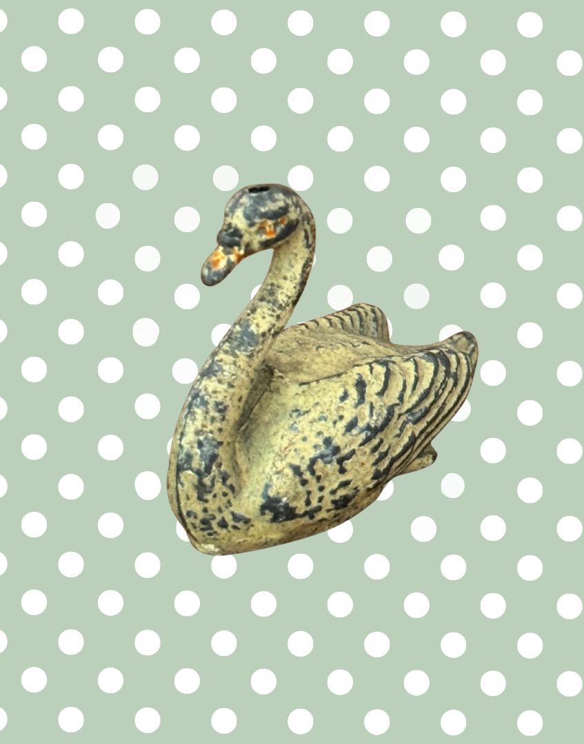 A cream swan swimming, version 2, showing some paint loss but retaining delicate shape and charm. This 1920s Britains figure is an ideal addition for collectors completing a vintage farmyard or waterfowl display.