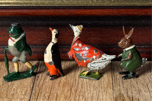 A group of vintage Cadbury Cococubs dating from the 1930s, highlighting the fascinating history of Britains lead toys and Cadbury advertising.