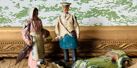 A collection of vintage Britains lead miniature figurines styled together on a shelf, featured in Whispers in Lead | The Magic of Britains Lead Toys.