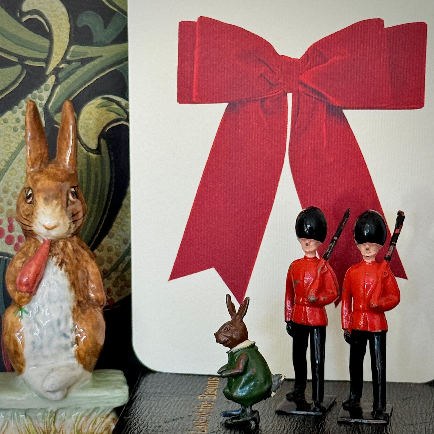 A collection of eclectic gifting for under £30 options from Love Nicki x including a pair of vintage toy soldiers, Brither Rabbit miniature Cadbury Cococub, gift card with red bow and rabbit figurine