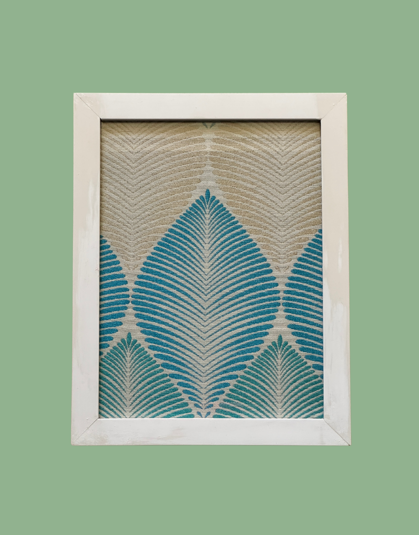 Framed artwork with blue and beige leaf pattern on a green background