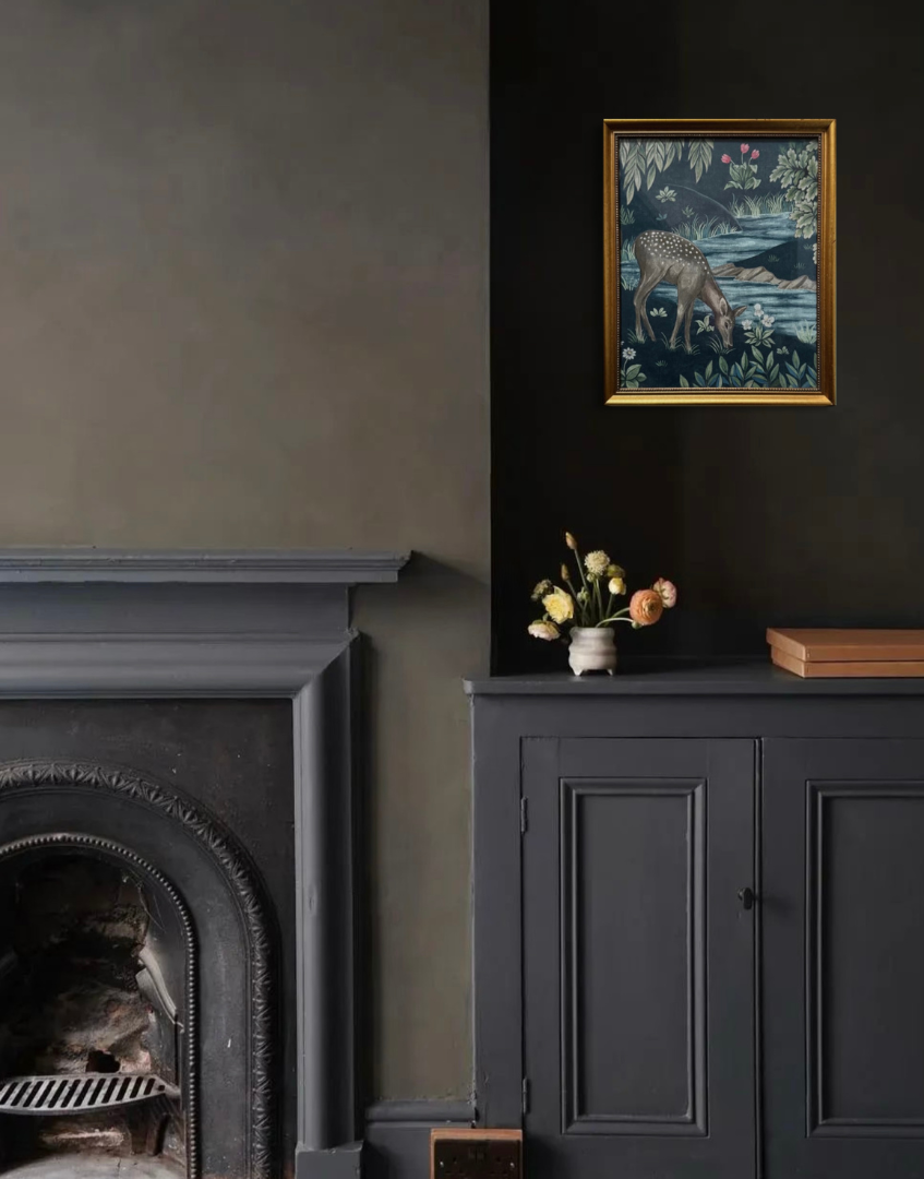 Dark interior with fireplace, cabinet, and vintage gold framed artwork on a dark wall.
