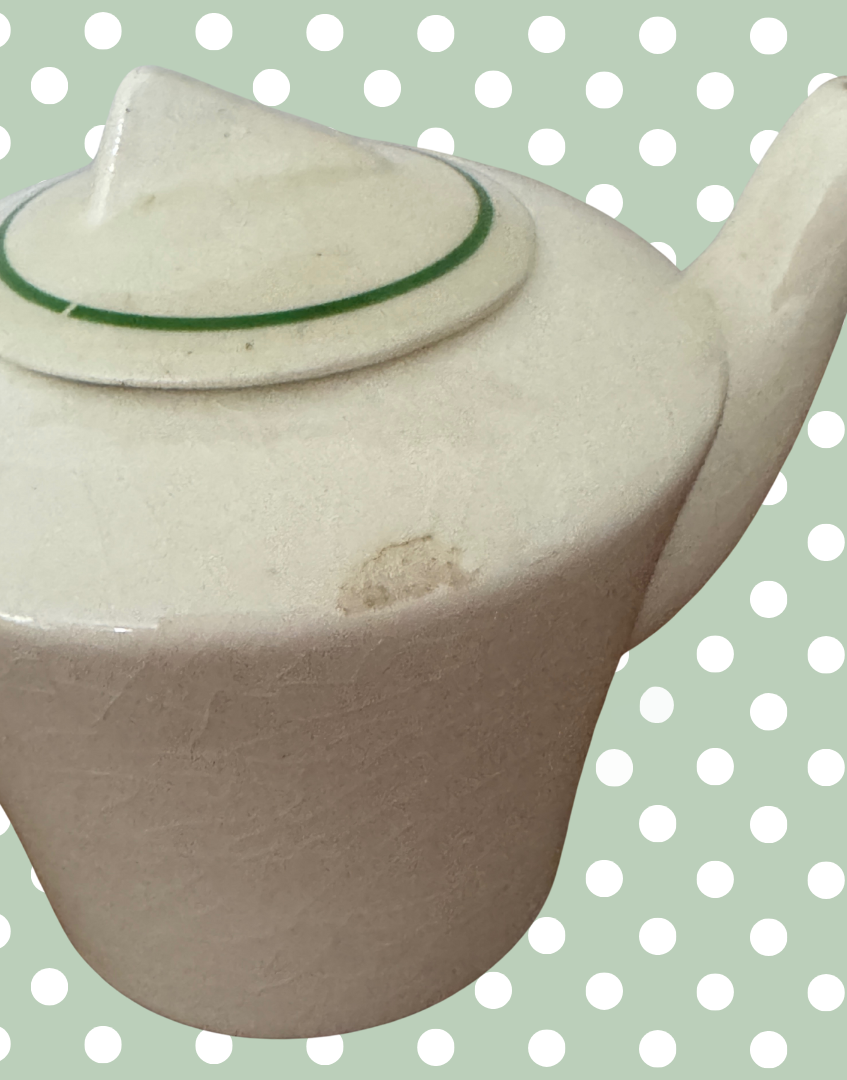 close up of small chip on side of art deco miniature childs playset teapot