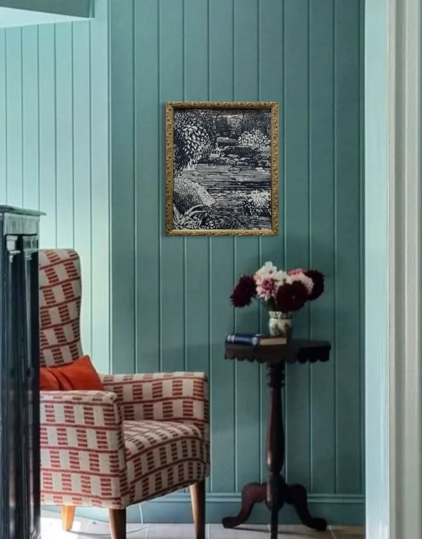Blue colour drench interior with red furnitshing accents and vintage gold framed balck and white landscape wall decor