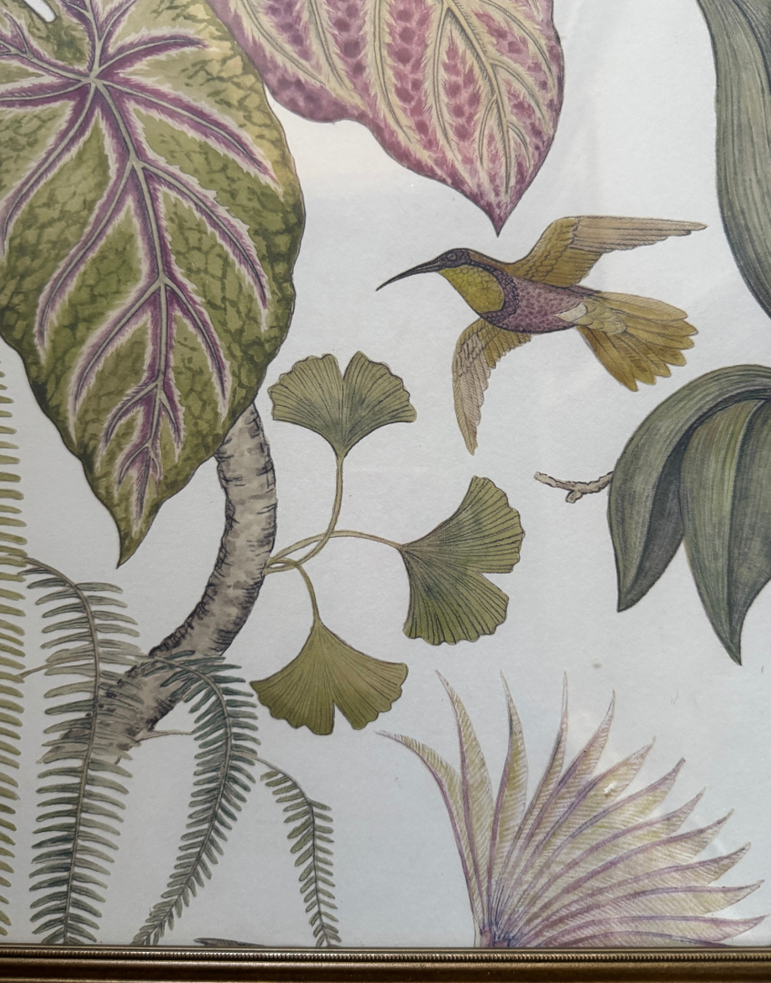 Decorative wall art with a hummingbird and leaf pattern on a white background
