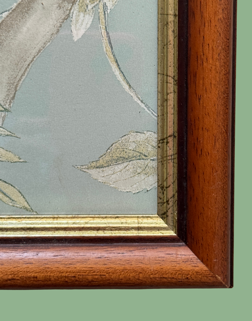 Close-up of a wooden frame with a floral print inside