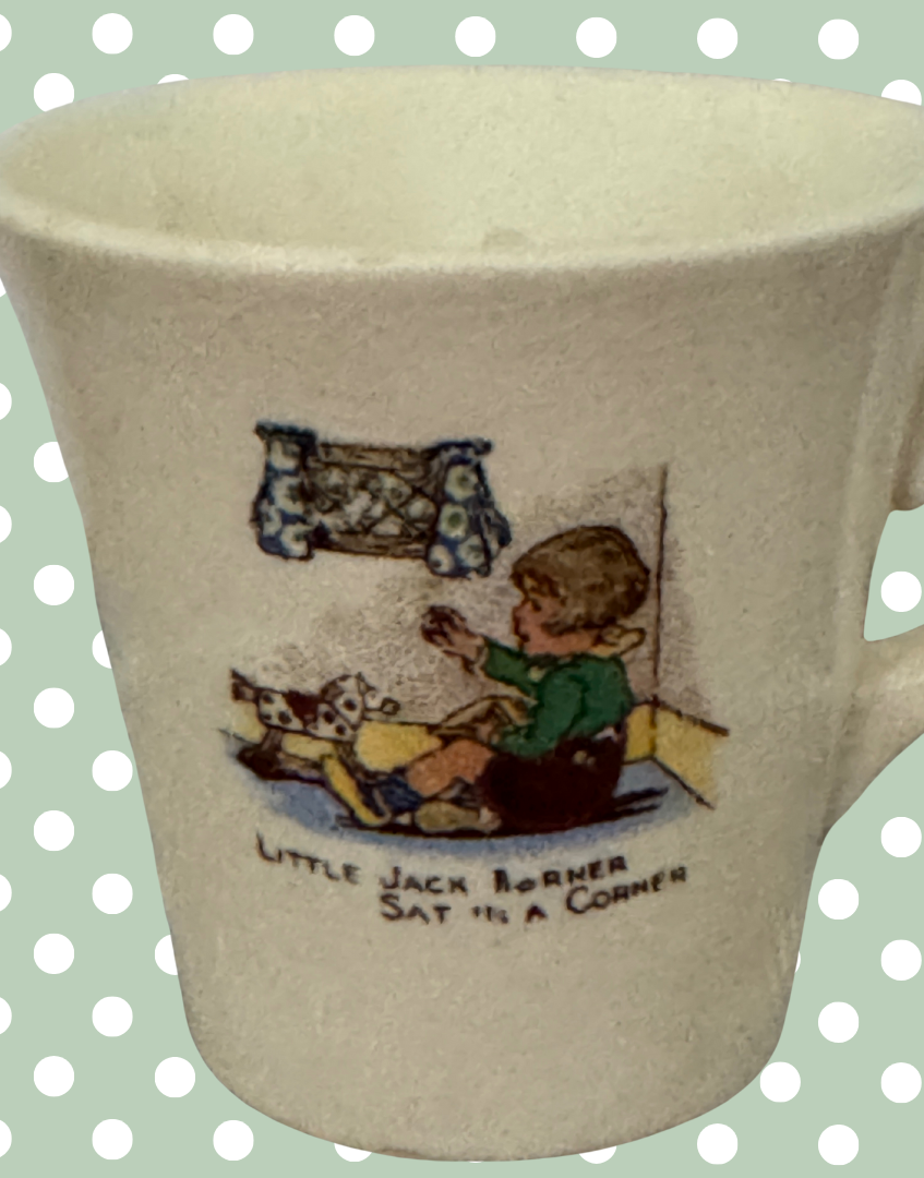 close up of little jack horner transfer ware illustration on vintage childs tea playset mug