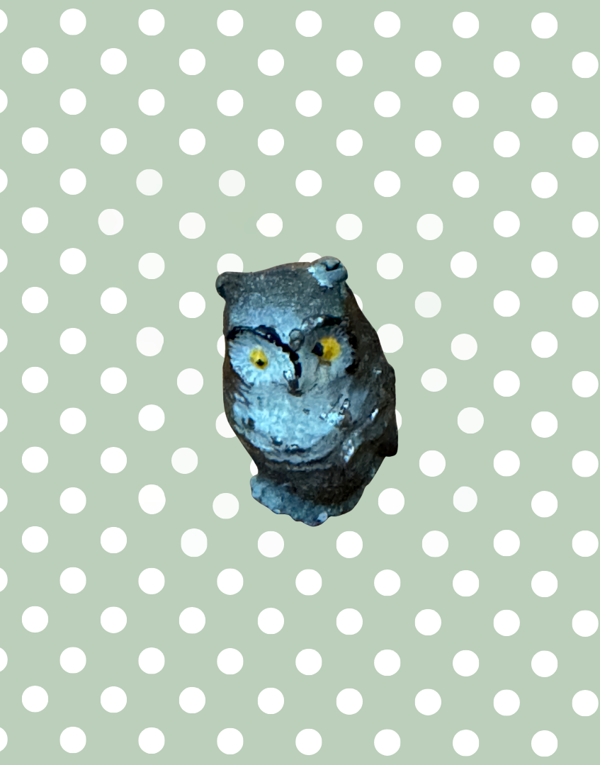 small vintage owl figurine with expressive yellow eyes