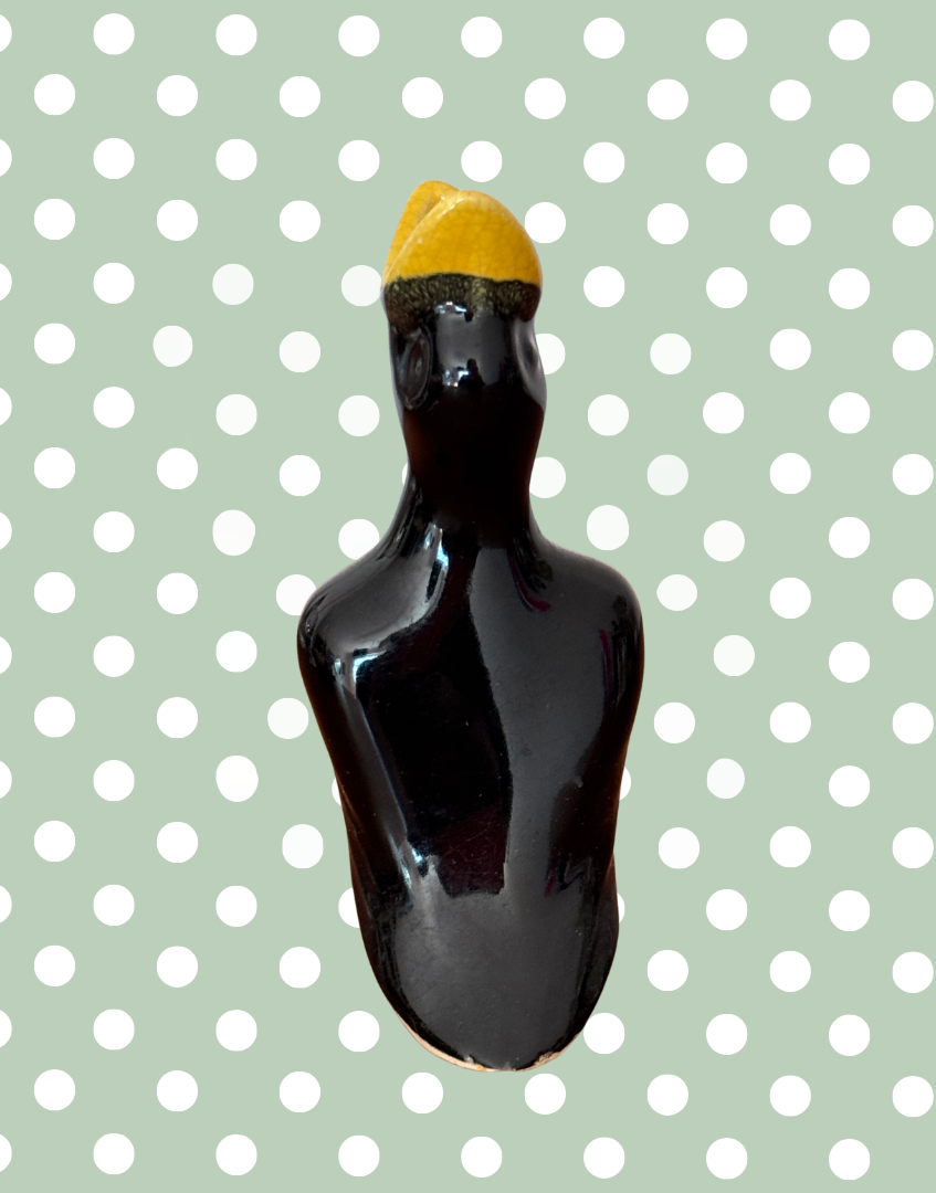 Back view of black and yellow glazed bird kitchen collectable