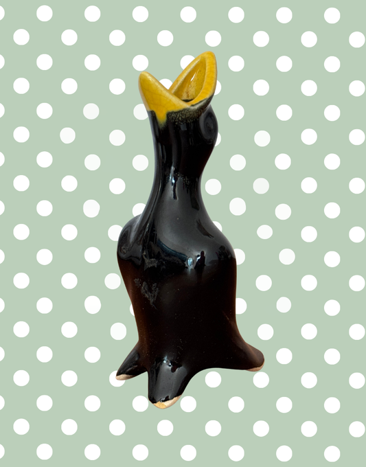 classic 1950s black and yellow pie bird with open mouth