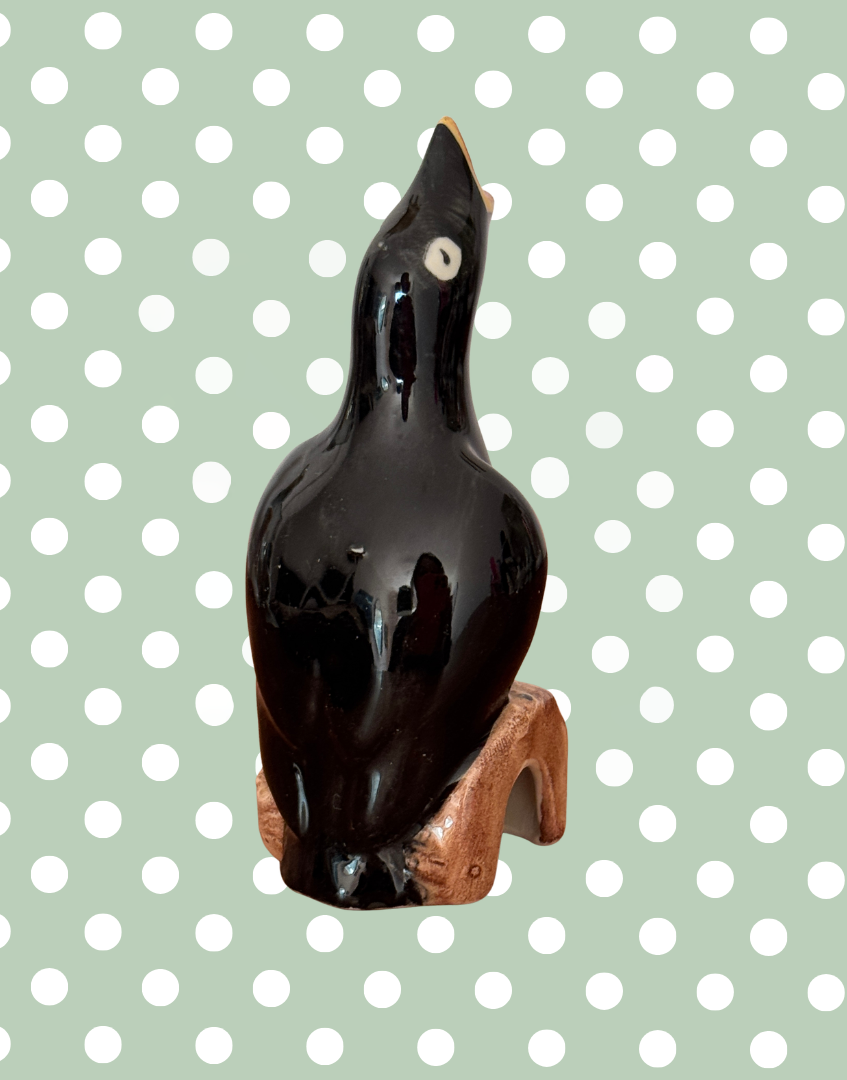 Back view of ceramic bak bird on log kitchenware