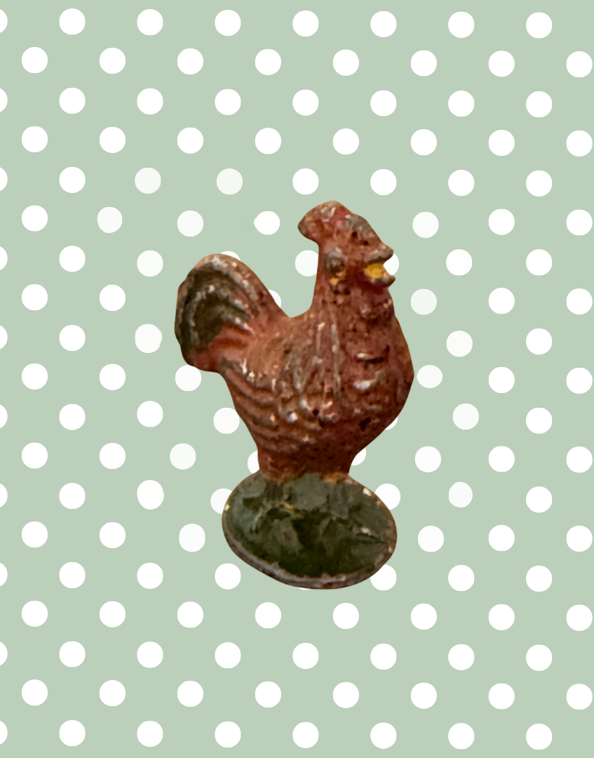 brown rooster lead figurine on green stand