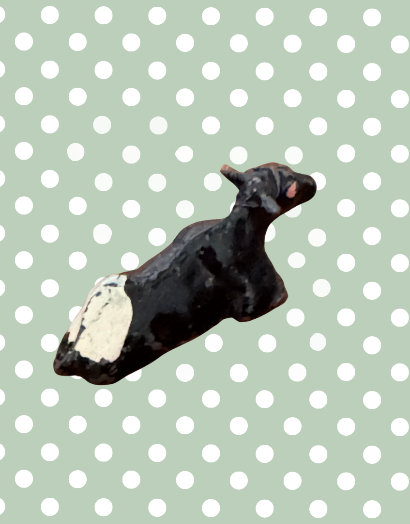 back view of black and white miniature calf antique lead farm toy