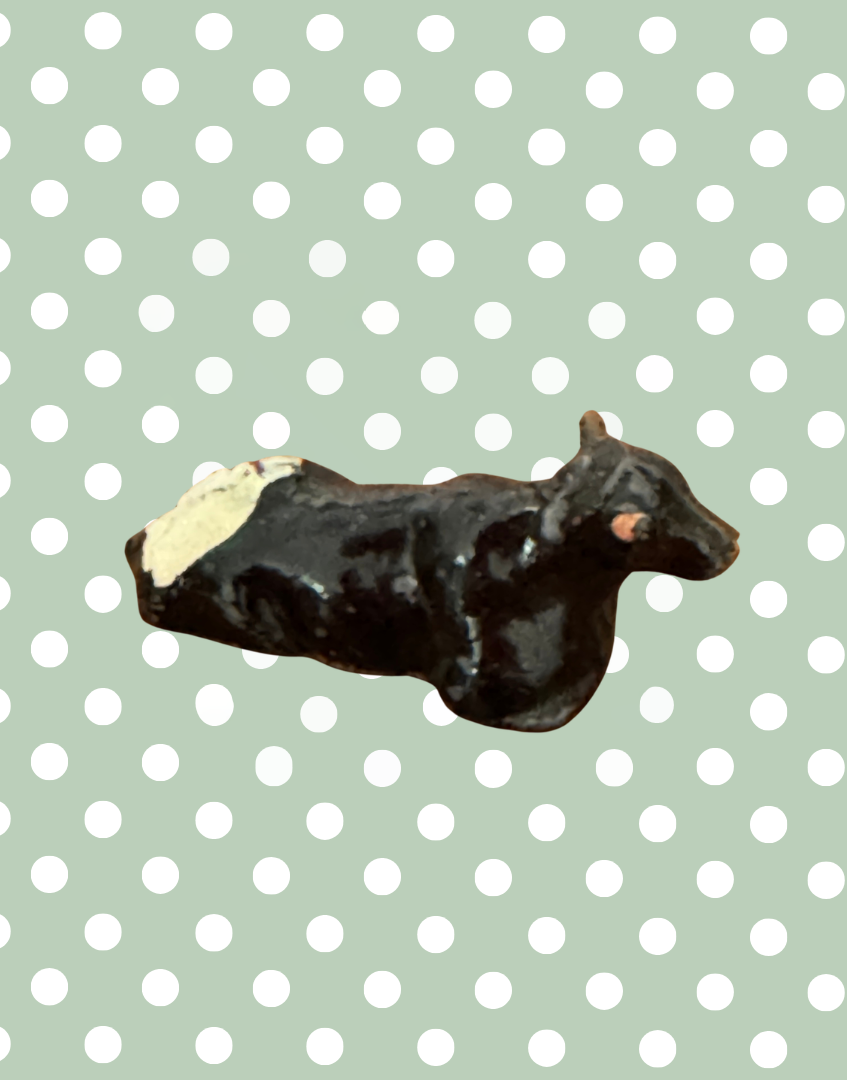 miniature lying black, white and pink hand painted lead figurine