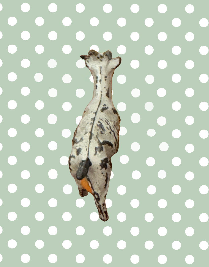 back view of small goat vintage lead figurine showing pink udder detail