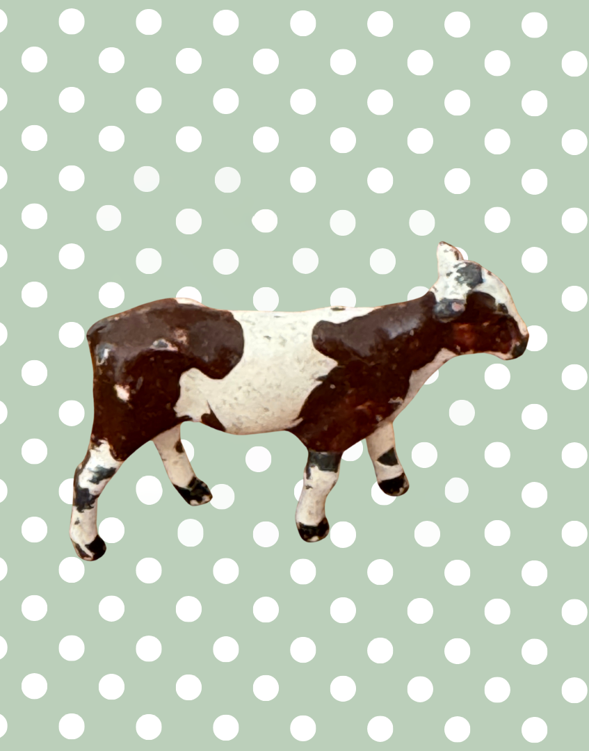 side view of brown and white sweet lead farm calf figurine