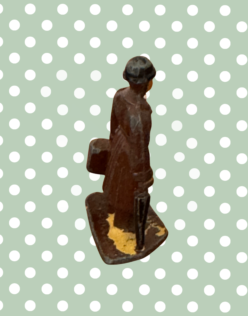 side back view of gentleman vintage lead figurine on stand