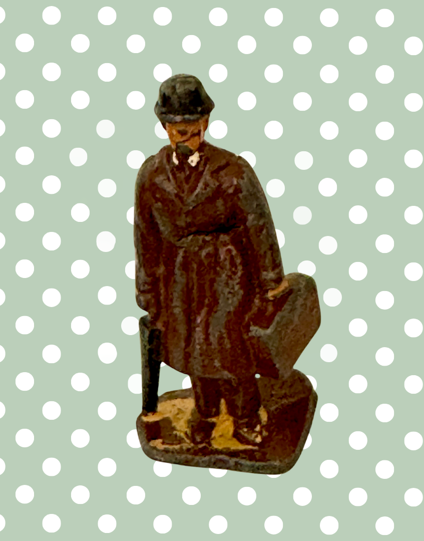 vintage lead figurine of commuter gentleman with bowler hat, trench coat, suitcase and umbrella 1930s