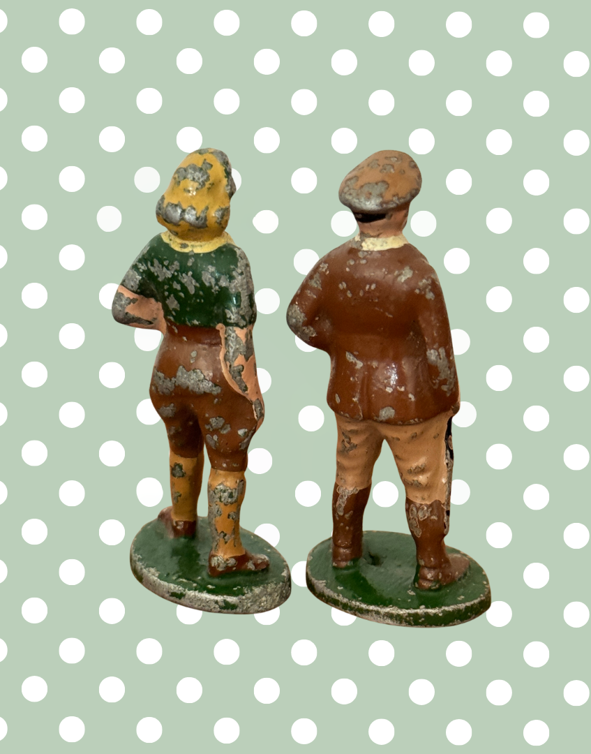 reverse side view of land girl and farm gent in breeches and traditional dress lead figurines