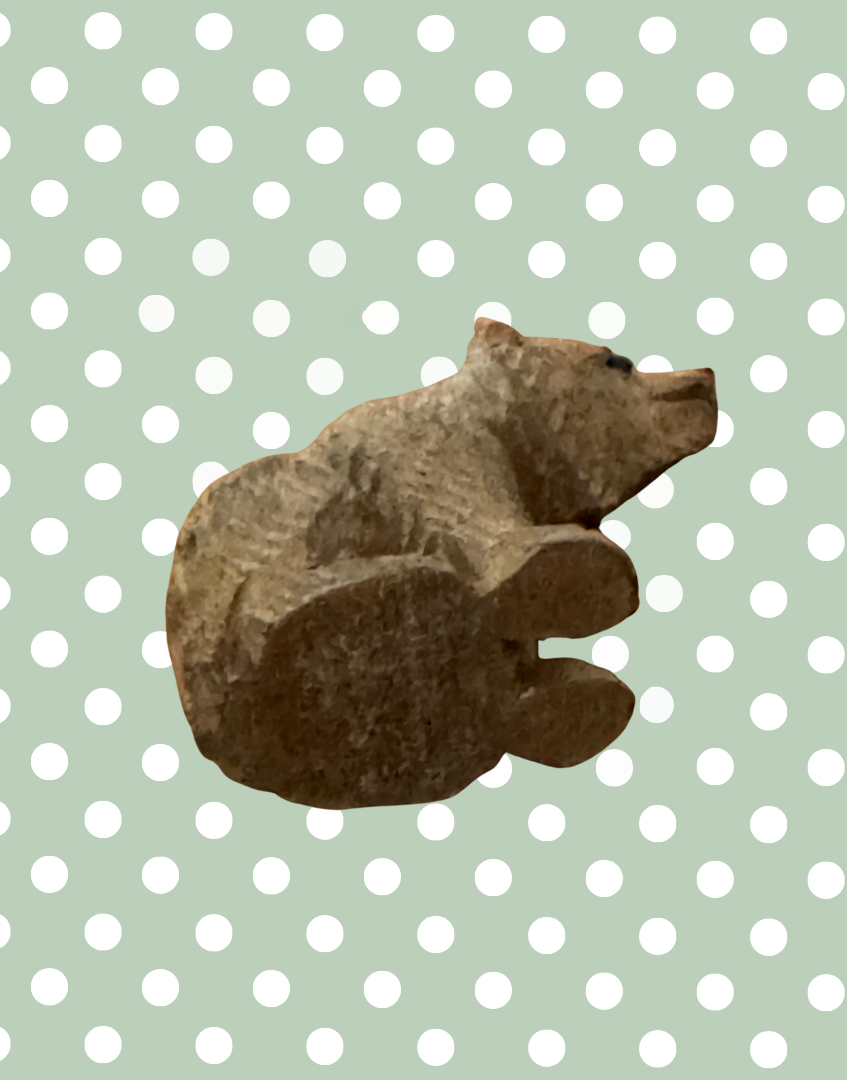 Small Black Forest bear carving base view showing underside detail