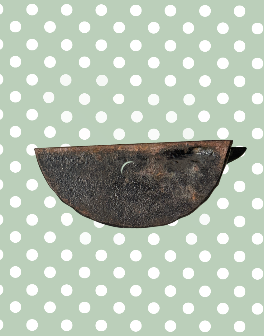 Base underside of vintage black cast iron frog doorstop showing aged surface wear