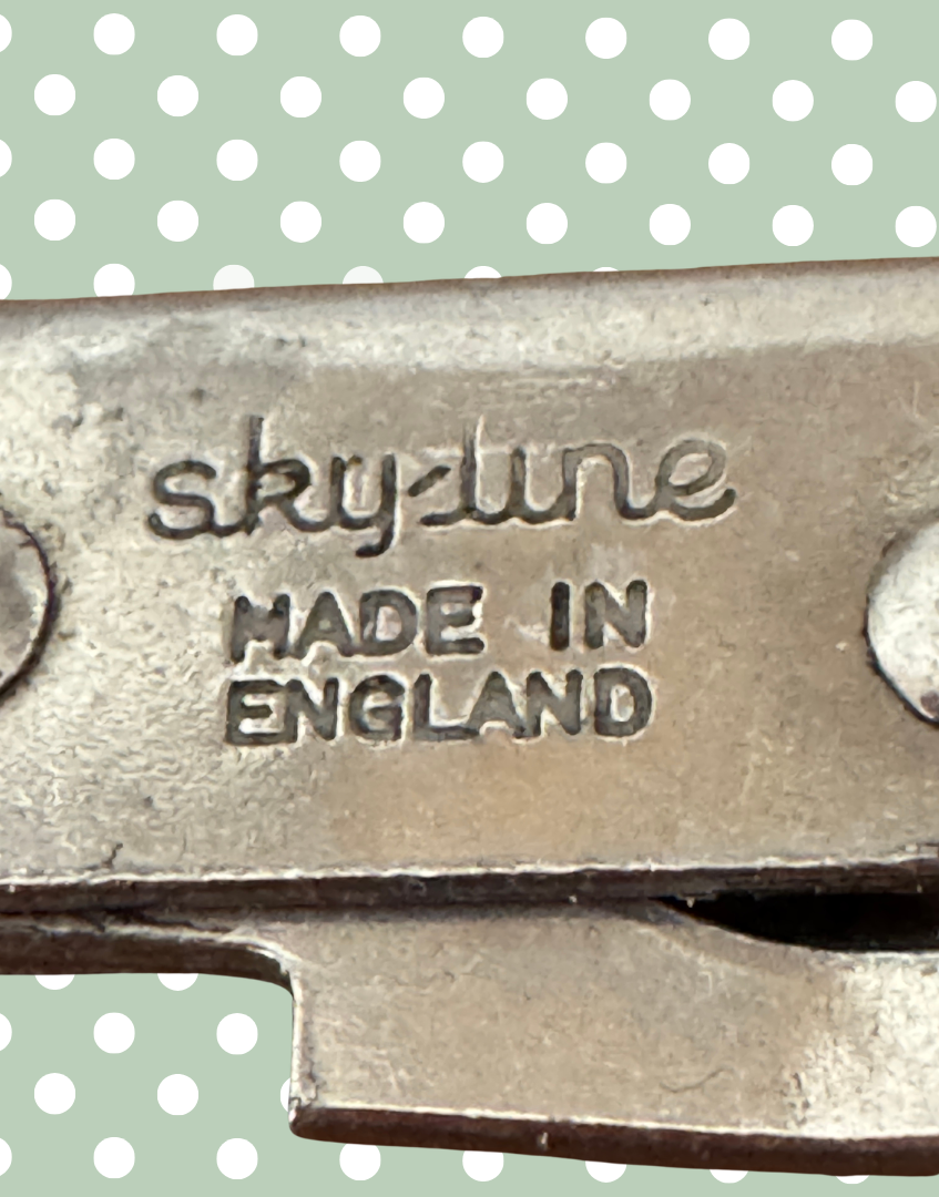 Close up of multifunctional kitchen opener with 'sky-line MADE IN ENGLAND' engraving
