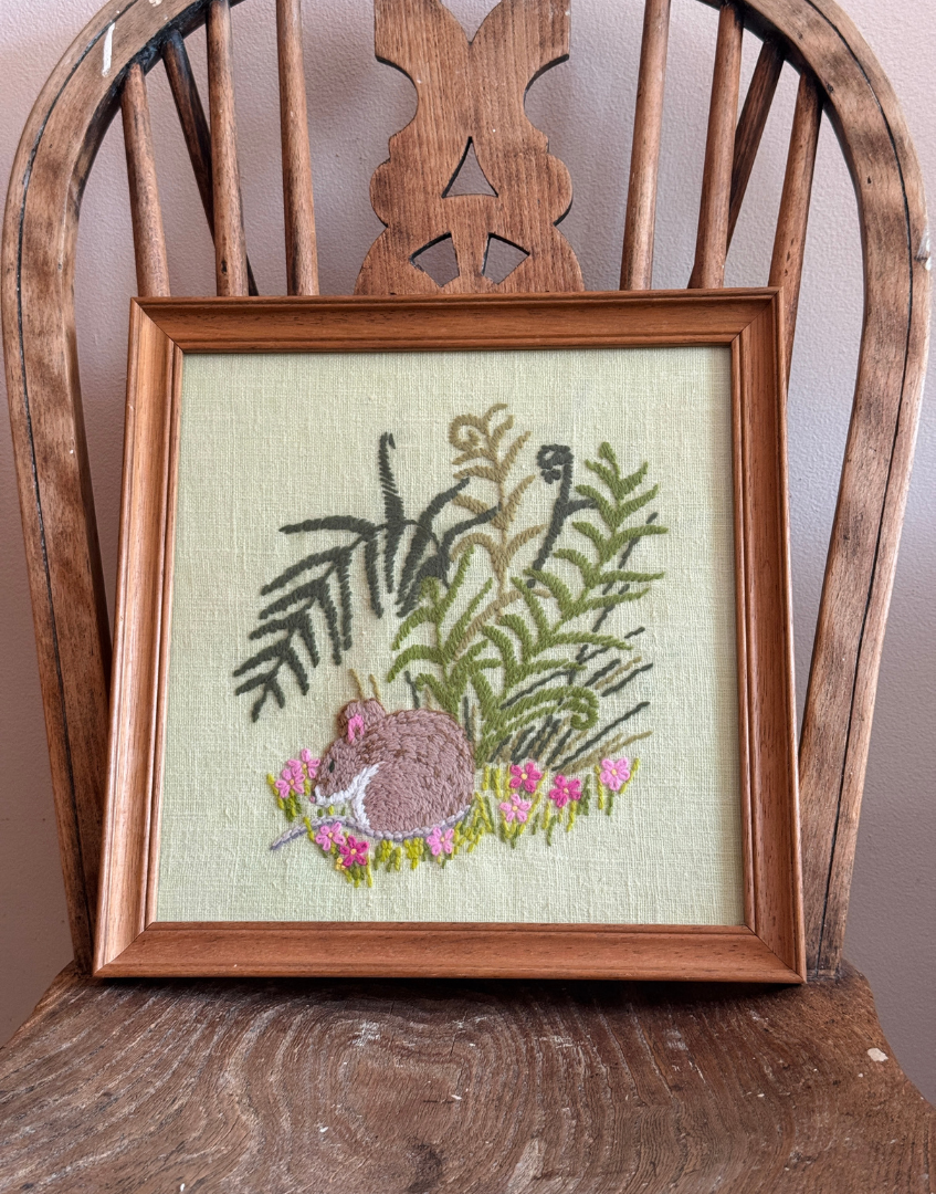 Vintage dormouse embroidery displayed on antique wooden chair with cosy cottage interior styling aesthetic