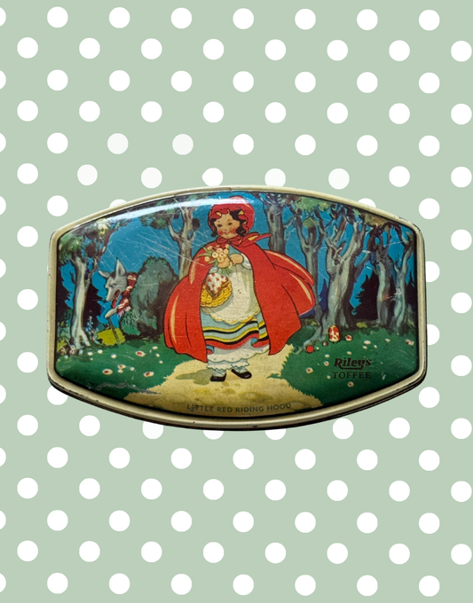 Top view of 1930s Rileys Toffee tin featuring Little Red Riding Hood walking through woodland with wolf illustration and mushroom detail