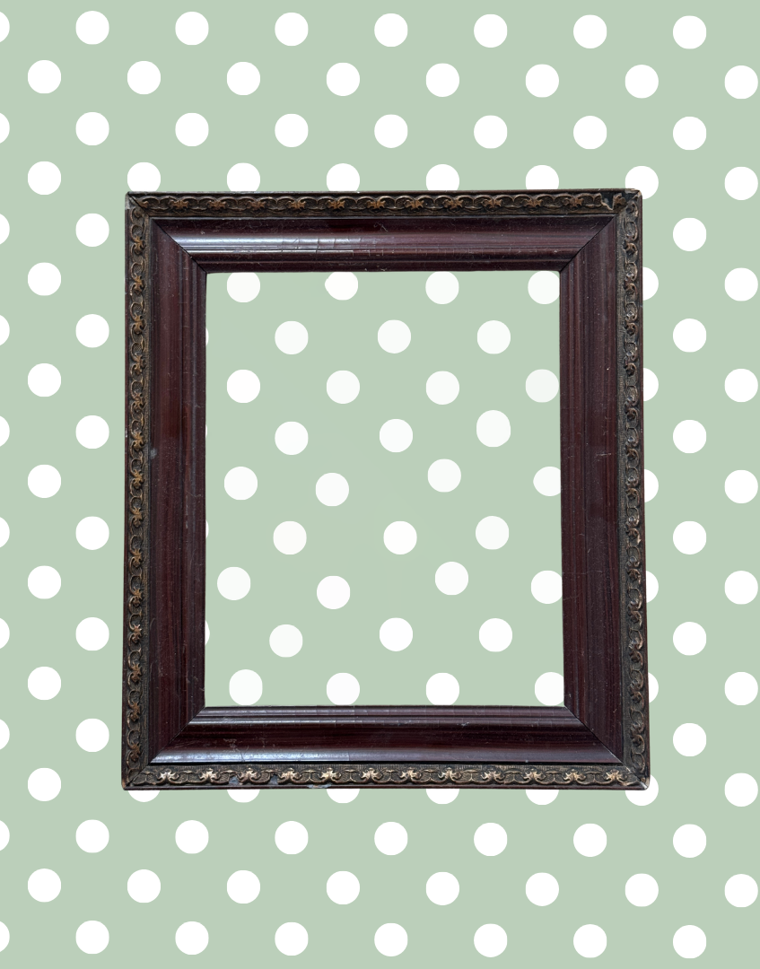 Antique decorative dark wood and metal picture frame with aged detailing and empty aperture.