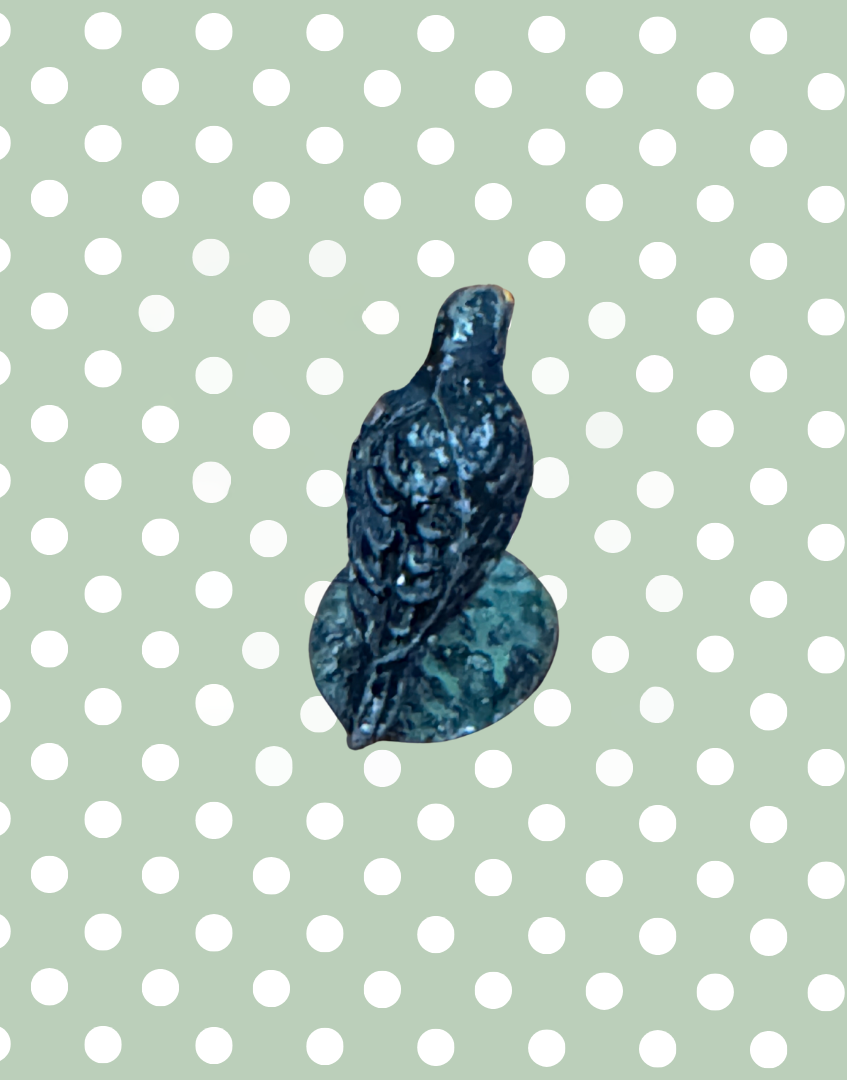 reverse view of vintage collectable crow figurine